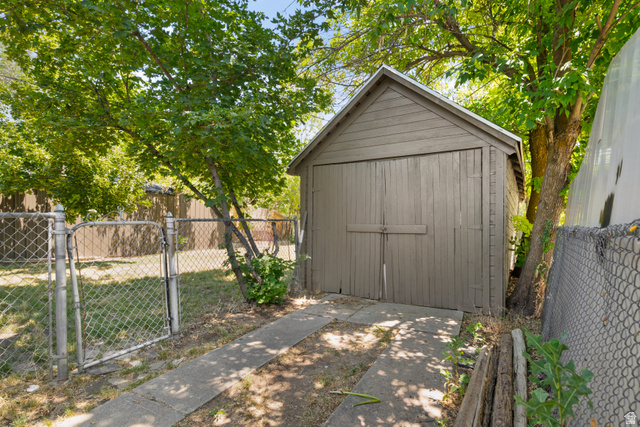 2862 Fowler Avenue Ogden, UT 84403 - Photo 6 of 23 Detached garage structure with double wooden doors and a pitched roof