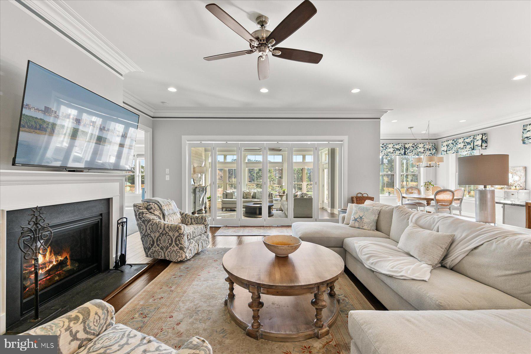 20822 Cormorant Way Ocean View, DE 19970 - Photo 23 of 91 a living room with furniture a fireplace and a large window
