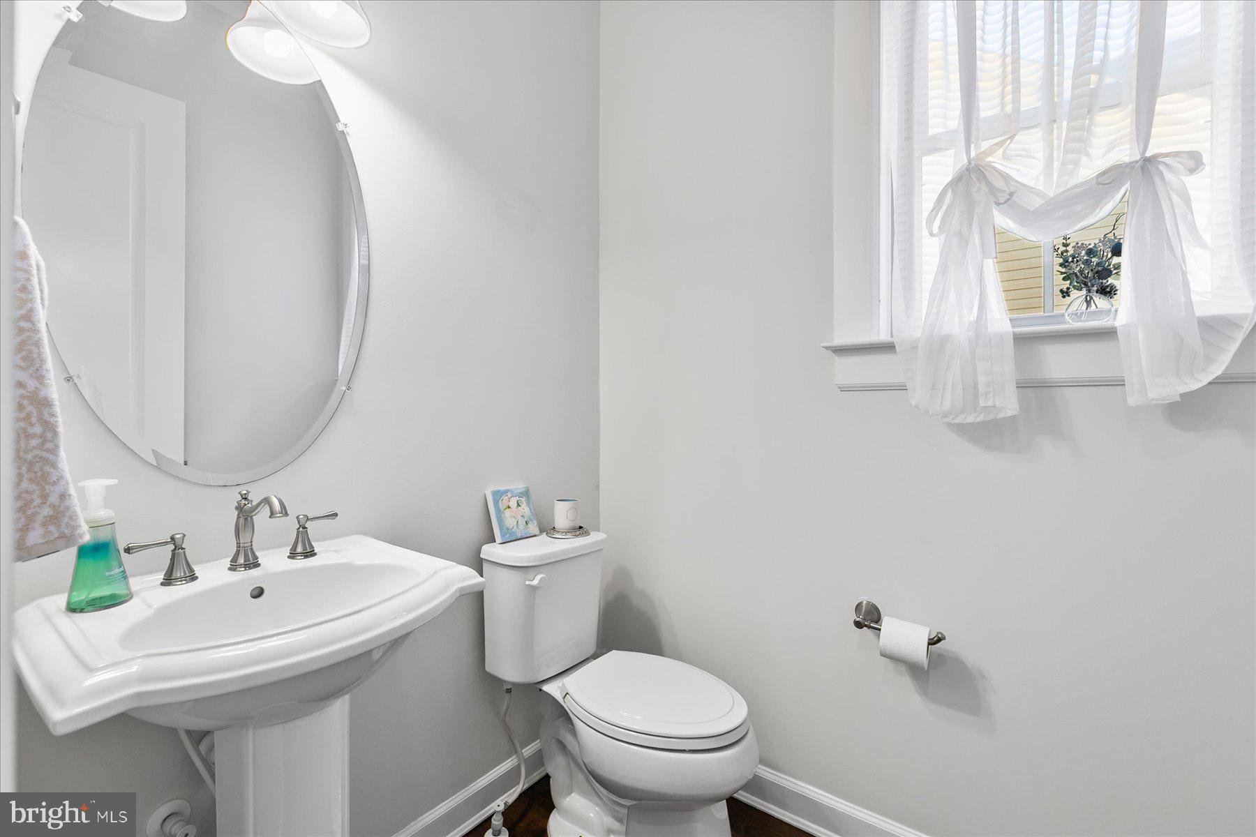 20822 Cormorant Way Ocean View, DE 19970 - Photo 26 of 91 a bathroom with a sink toilet and a mirror