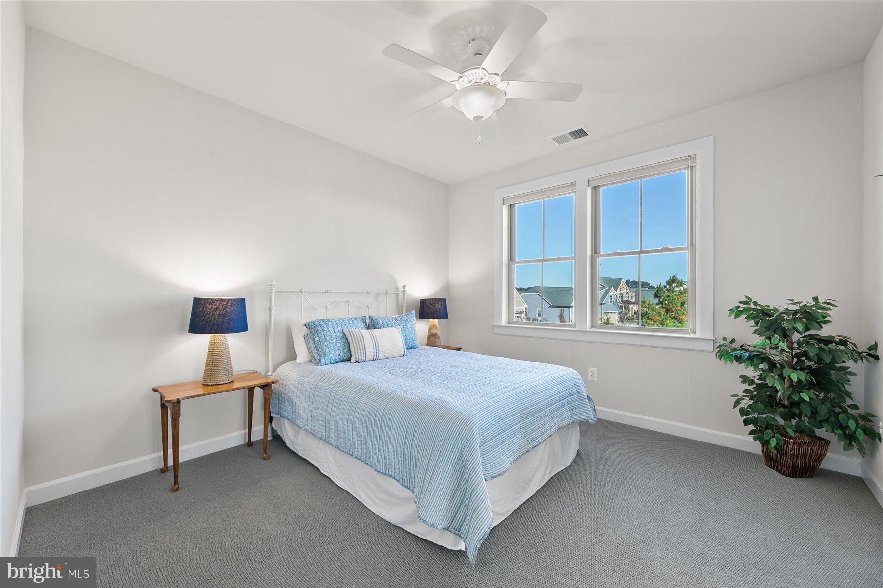 20822 Cormorant Way Ocean View, DE 19970 - Photo 27 of 91 a bedroom with a large bed and a window