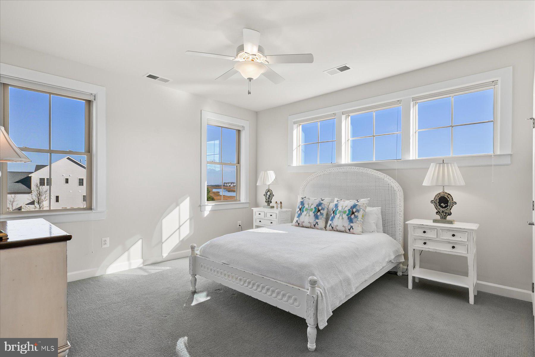 20822 Cormorant Way Ocean View, DE 19970 - Photo 32 of 91 a bedroom with a bed and a chandelier