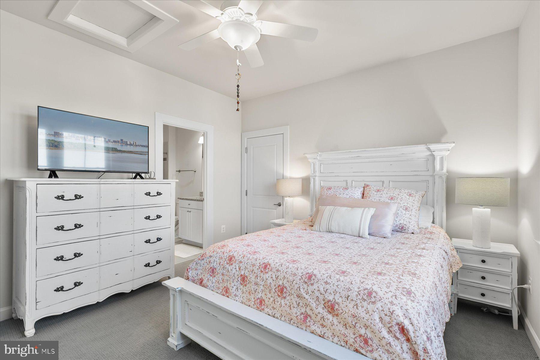 20822 Cormorant Way Ocean View, DE 19970 - Photo 40 of 91 a bedroom with a large bed and a flat tv screen on dresser