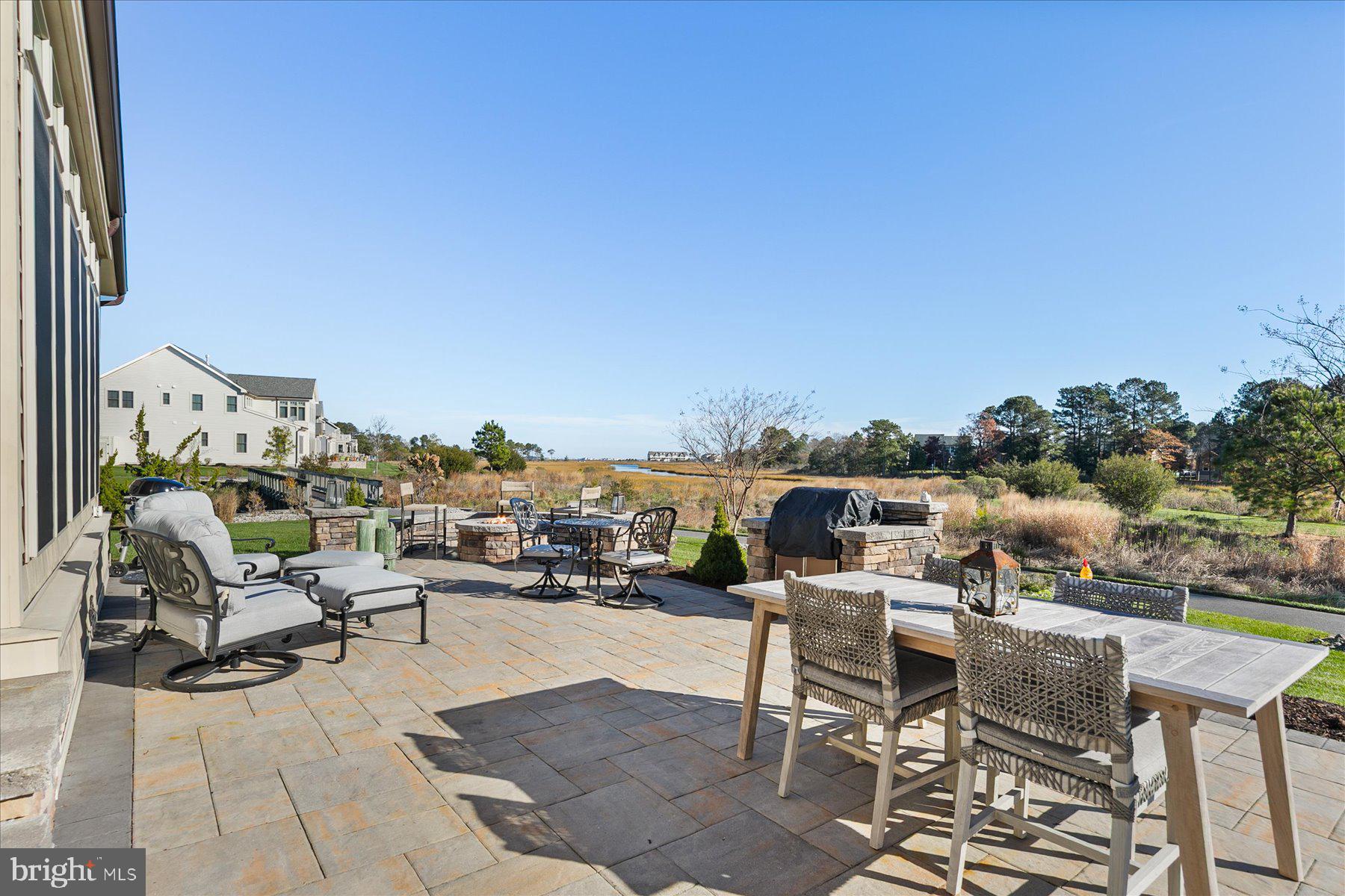 20822 Cormorant Way Ocean View, DE 19970 - Photo 54 of 91 a view of a terrace with furniture and a fire pit