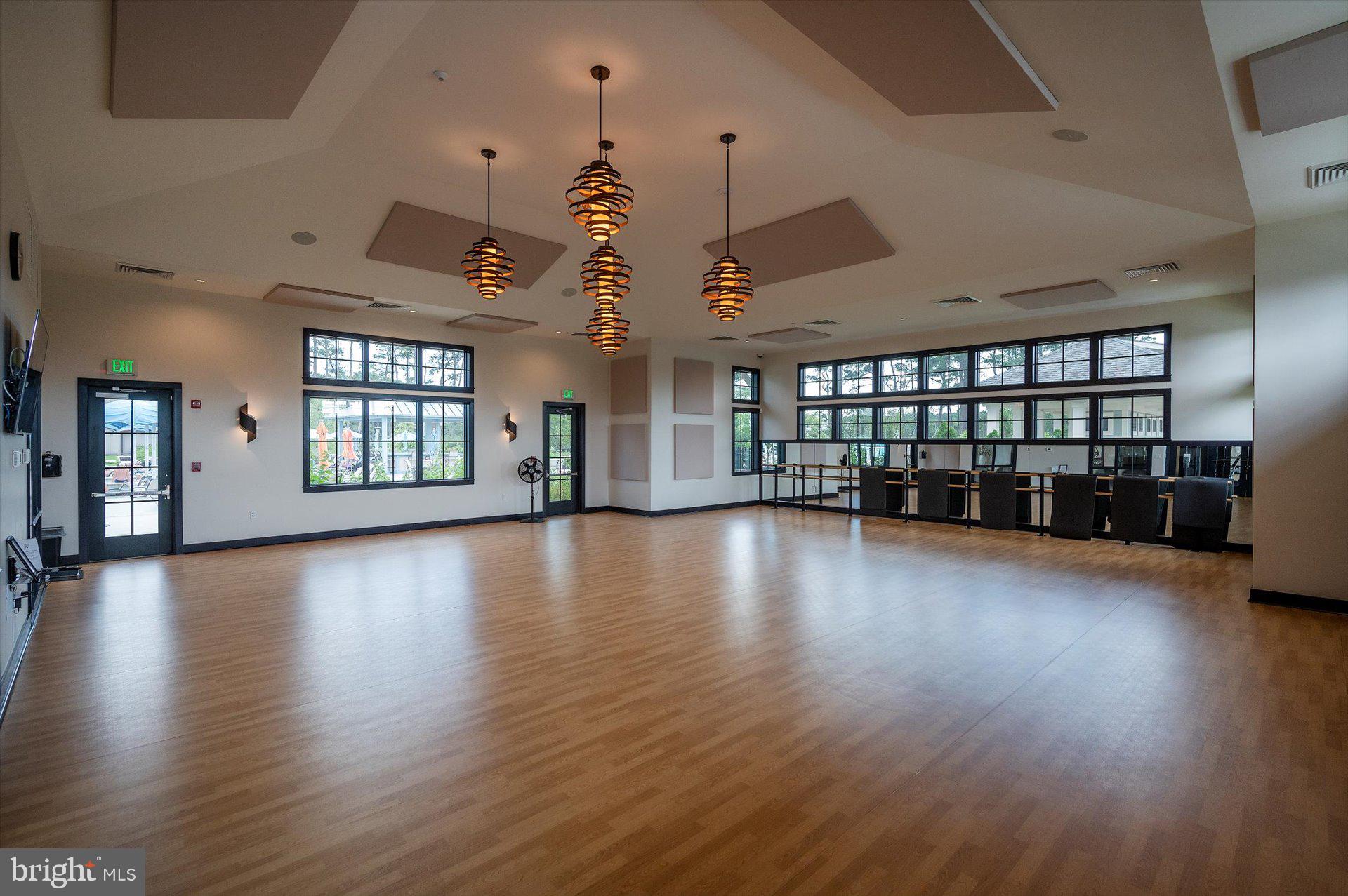 20822 Cormorant Way Ocean View, DE 19970 - Photo 87 of 91 an empty room with hard wood floors ceiling fans and windows