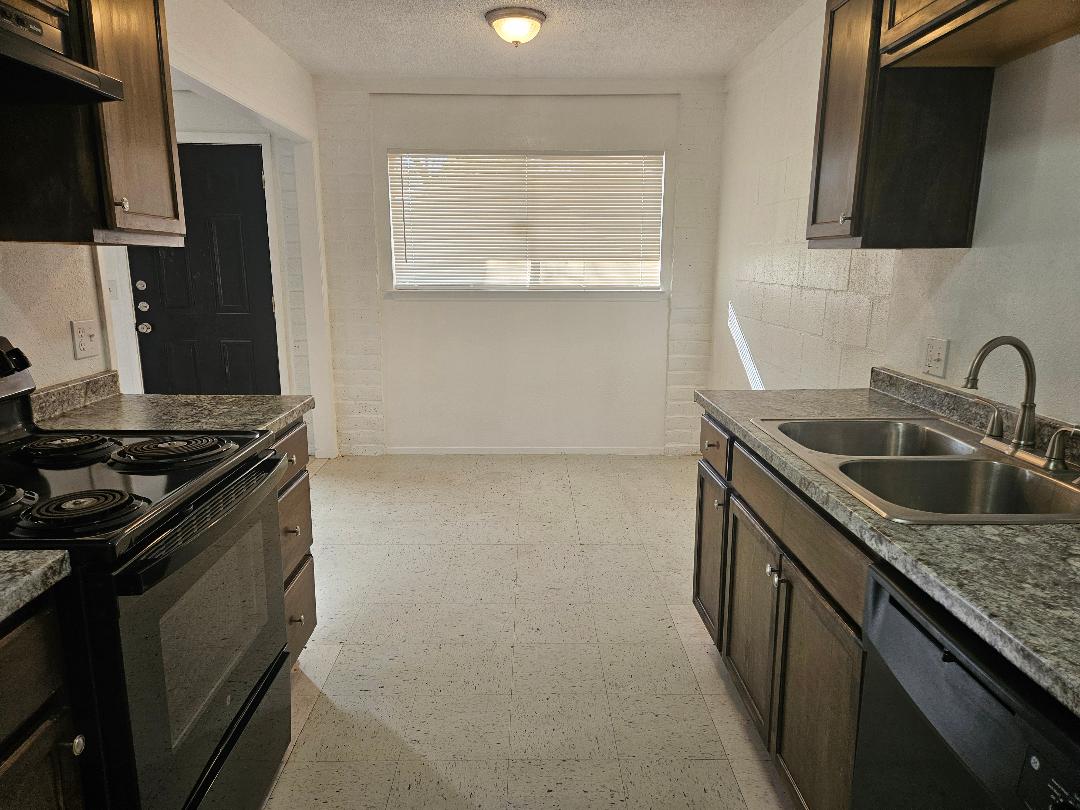 410 East 9th Street, Unit C Elgin, TX 78621 - Photo 4 of 11 a kitchen that has a sink and a stove