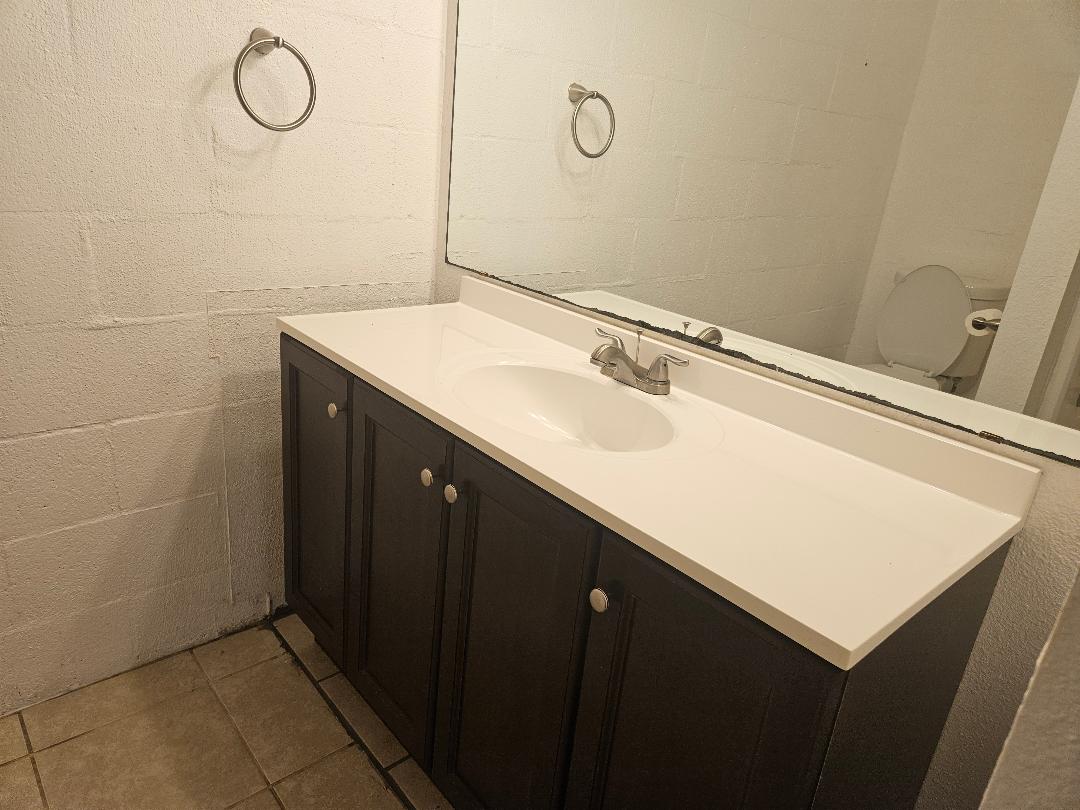 410 East 9th Street, Unit C Elgin, TX 78621 - Photo 8 of 11 a bathroom with a sink vanity and mirror