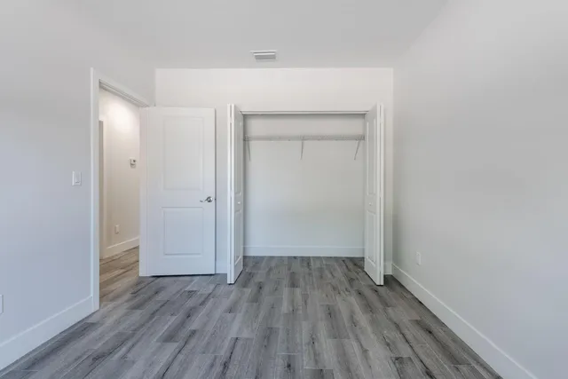 a view of a room with wooden floor