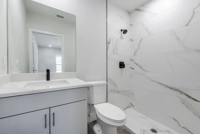 a bathroom with a sink toilet and shower