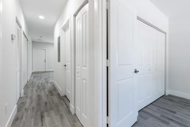 a view of a hallway with wooden floor