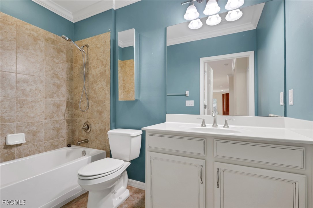 4210 Dutchess Park Road Fort Myers, FL 33916 - Photo 17 of 36 a bathroom with a sink a toilet a mirror a vanity and bathtub