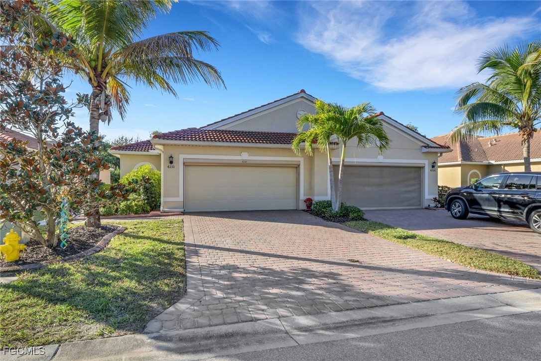 4210 Dutchess Park Road Fort Myers, FL 33916 - Photo 22 of 36 a front view of a house with garden