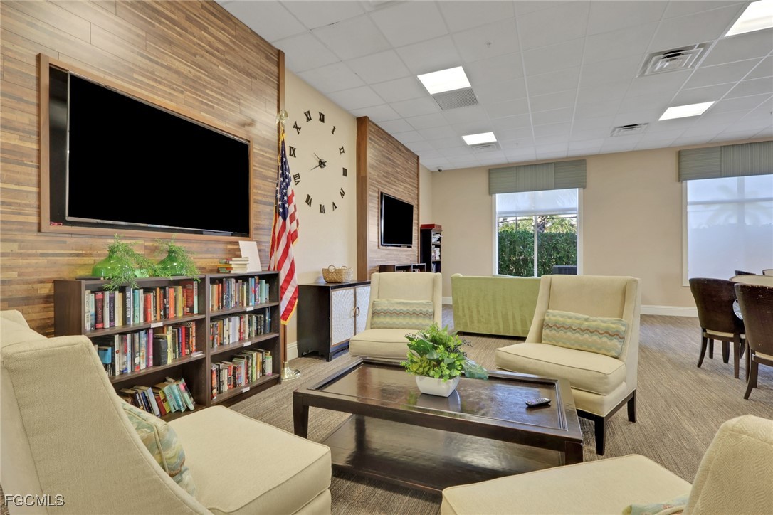 4210 Dutchess Park Road Fort Myers, FL 33916 - Photo 29 of 36 a living room with furniture wooden floor and a flat screen tv