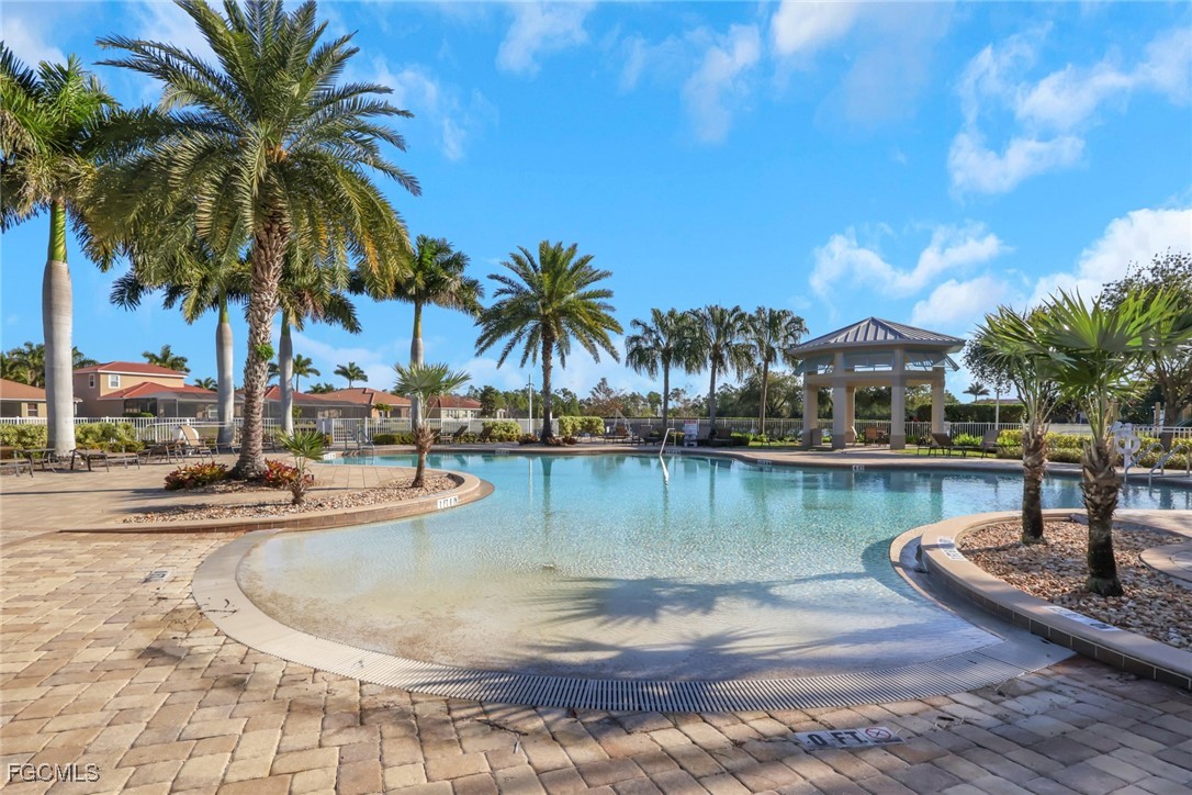 4210 Dutchess Park Road Fort Myers, FL 33916 - Photo 4 of 36 a view of a swimming pool with a table and chairs