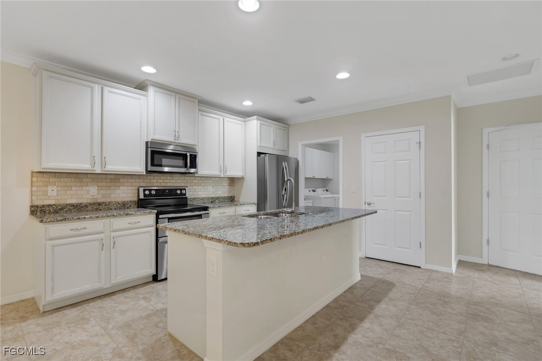 4210 Dutchess Park Road Fort Myers, FL 33916 - Photo 7 of 36 a kitchen with stainless steel appliances granite countertop a sink stove and microwave