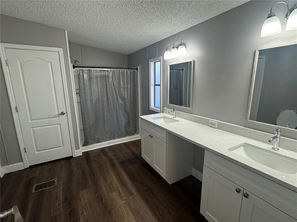 5254 Mt Olive Road Polk City, FL 33868 - Photo 14 of 19 a bathroom with a double vanity sink and mirror