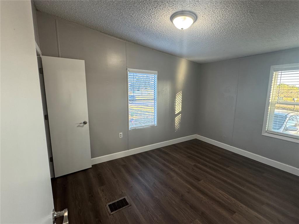 5254 Mt Olive Road Polk City, FL 33868 - Photo 15 of 19 an empty room with wooden floor and windows