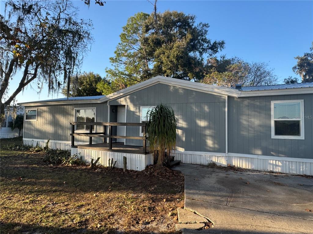 5254 Mt Olive Road Polk City, FL 33868 - Photo 3 of 19 a front view of a house with garden