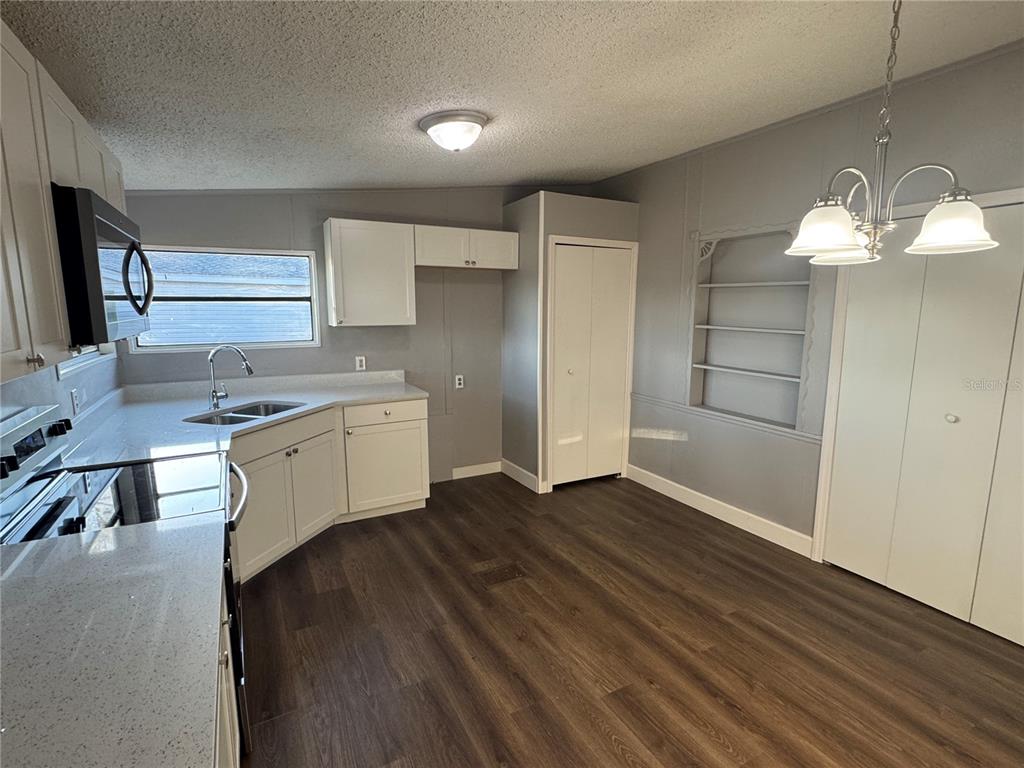 5254 Mt Olive Road Polk City, FL 33868 - Photo 5 of 19 a kitchen with a sink cabinets and wooden floor