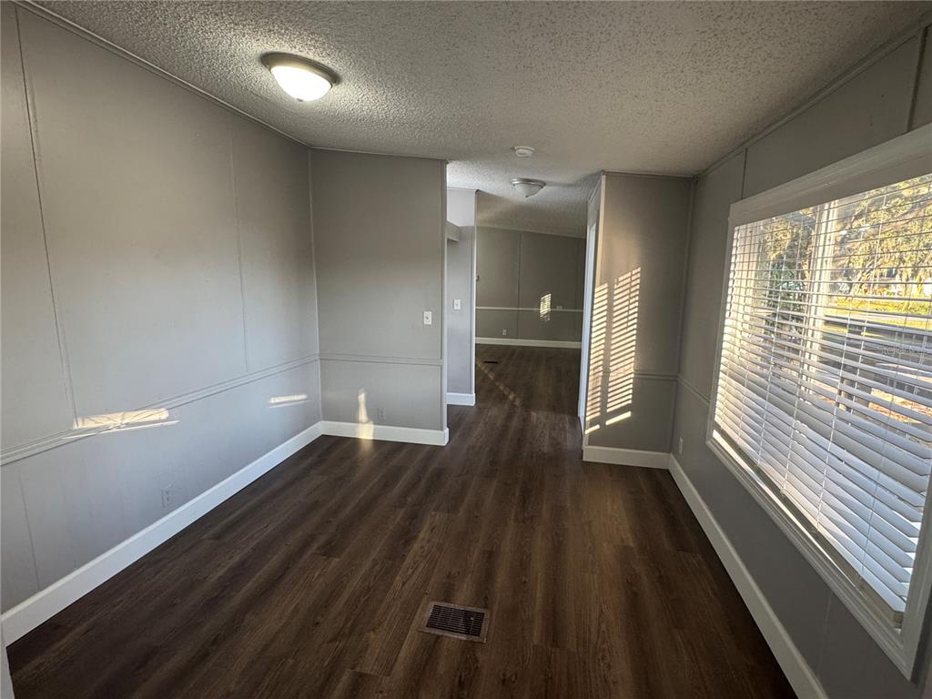 5254 Mt Olive Road Polk City, FL 33868 - Photo 8 of 19 wooden floor in an empty room with a window