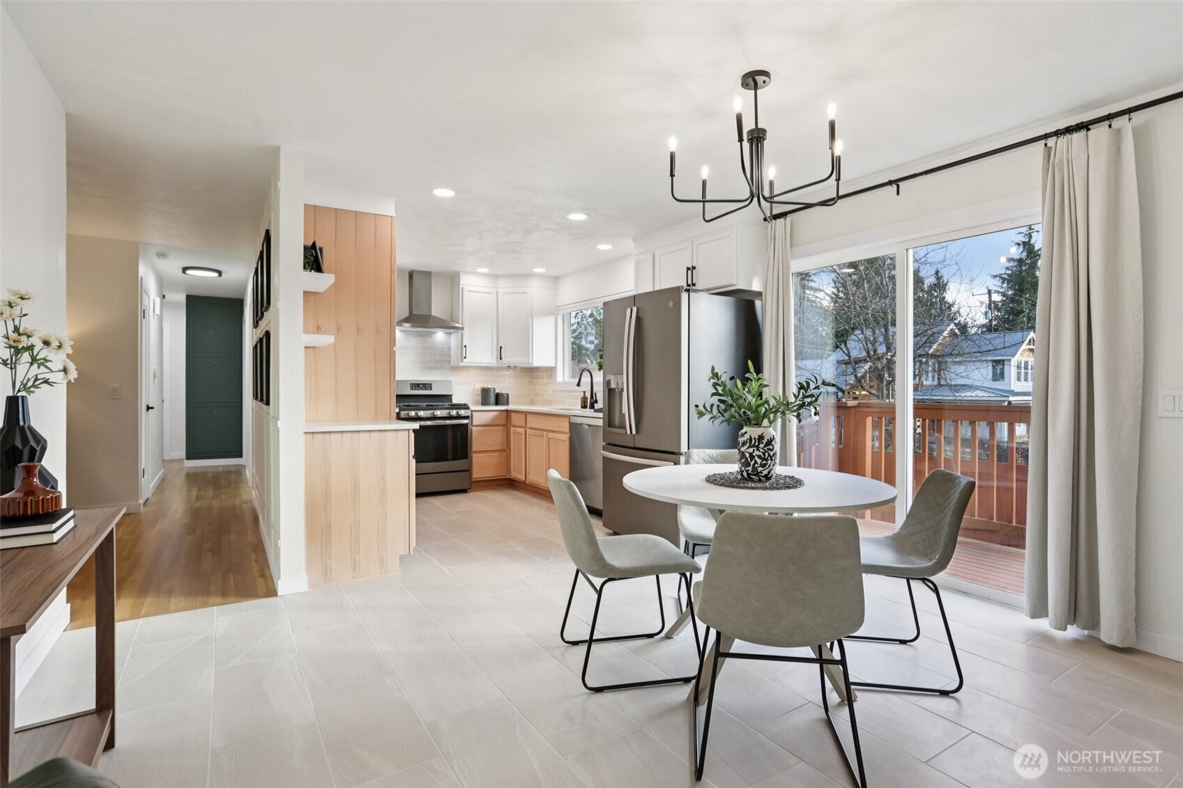 9002 34th Avenue Southwest Seattle, WA 98126 - Photo 16 of 39 a view of a dining room with furniture a chandelier and kitchen view