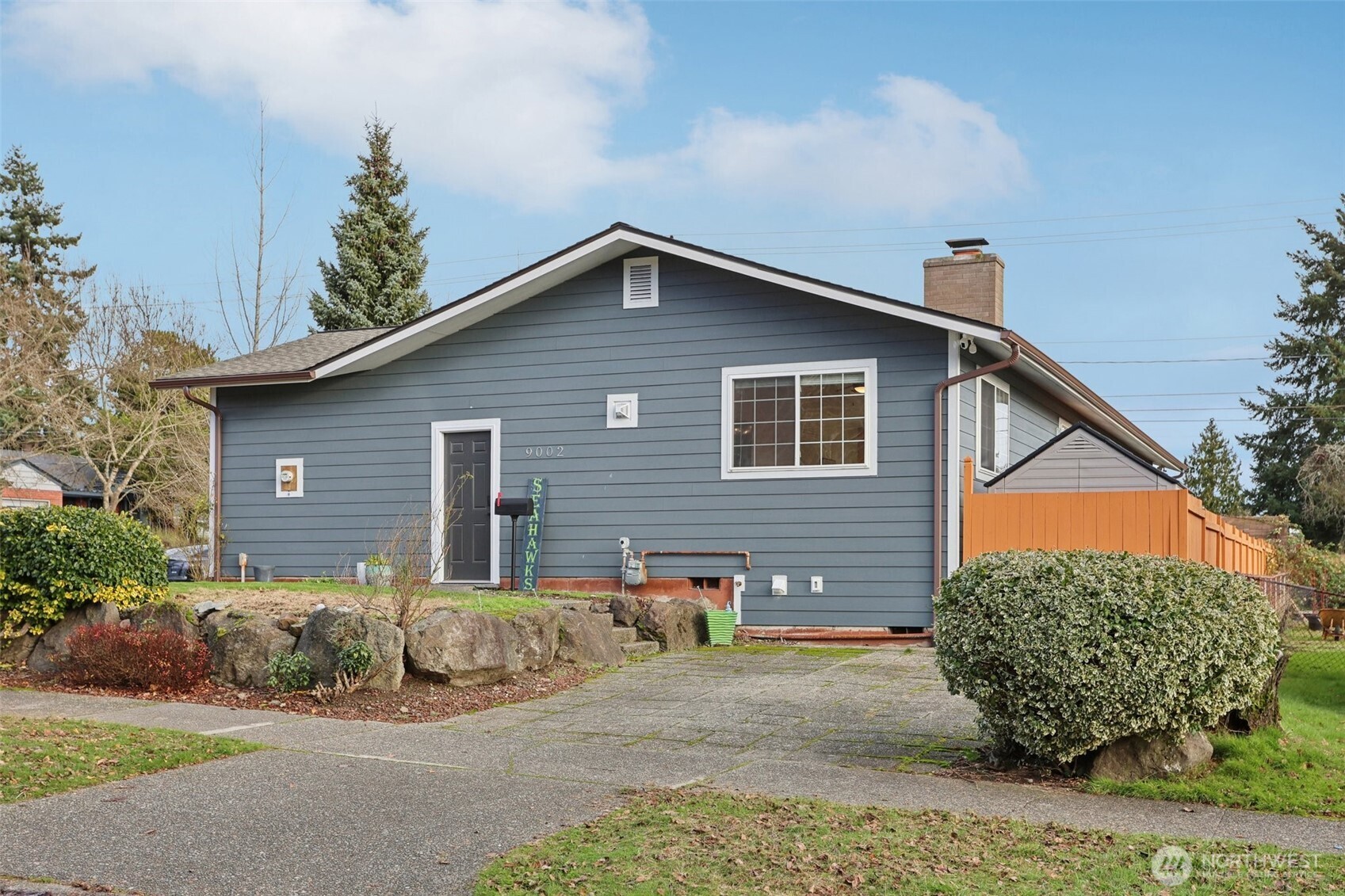 9002 34th Avenue Southwest Seattle, WA 98126 - Photo 34 of 39 a front view of a house with a yard and garage