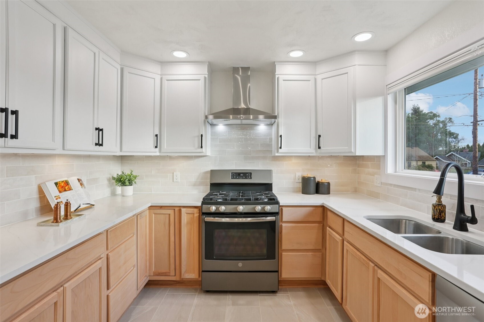 9002 34th Avenue Southwest Seattle, WA 98126 - Photo 4 of 39 a kitchen with white cabinets and appliances