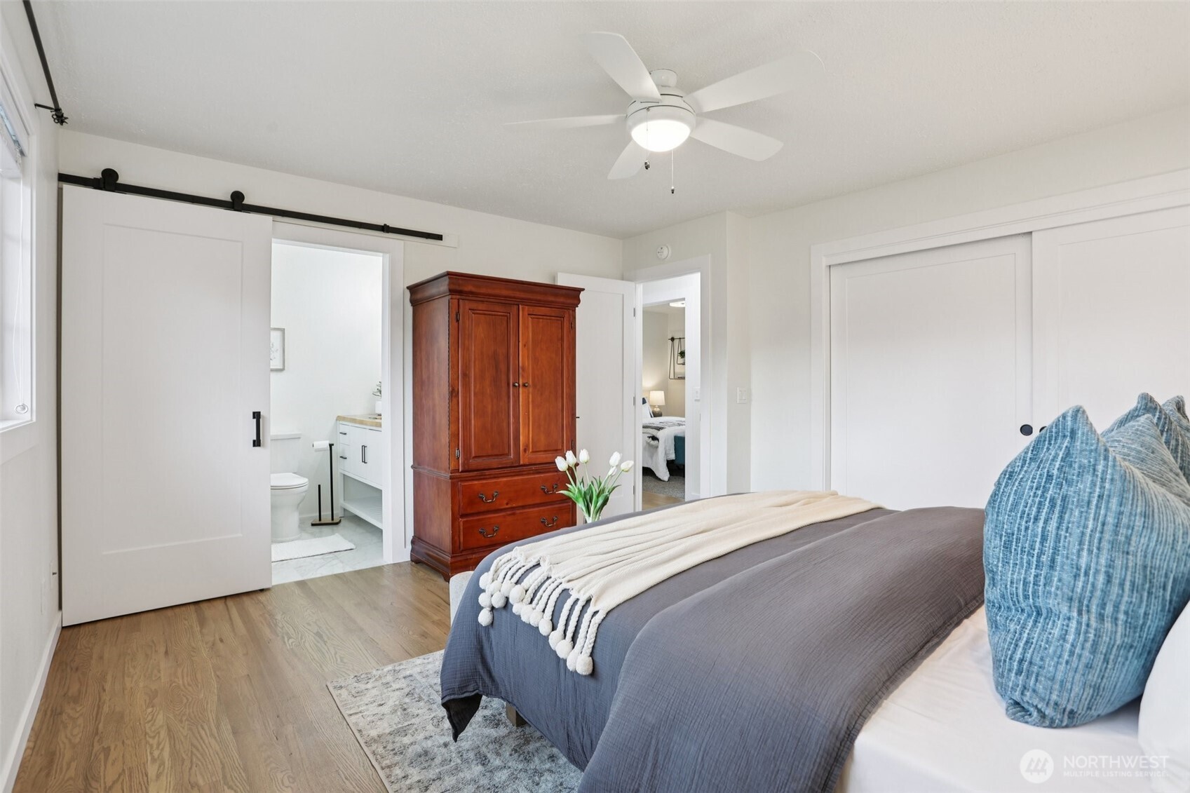 9002 34th Avenue Southwest Seattle, WA 98126 - Photo 8 of 39 a bedroom with a bed and a chandelier