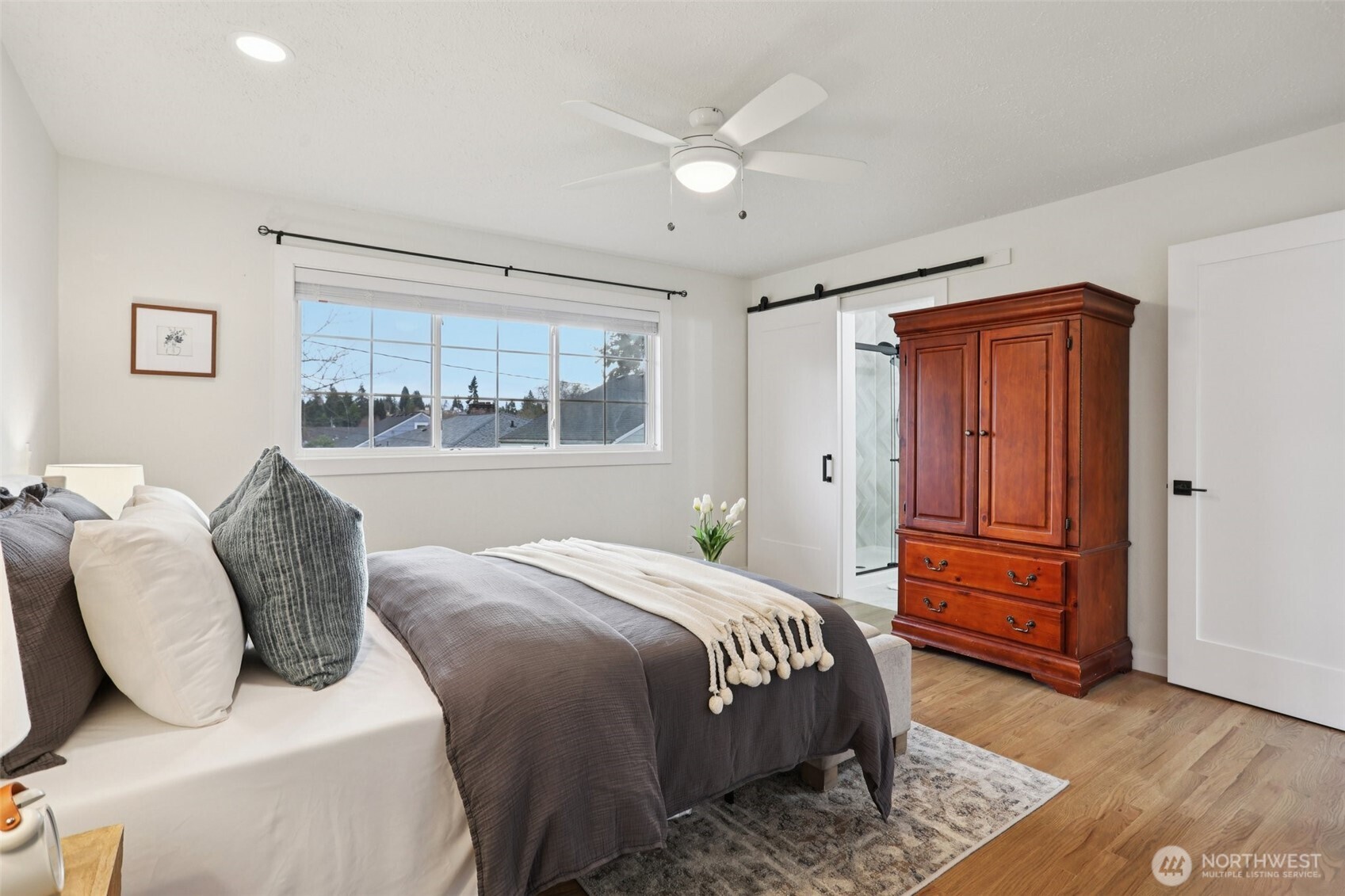 9002 34th Avenue Southwest Seattle, WA 98126 - Photo 9 of 39 a bedroom with a large bed and wooden floor
