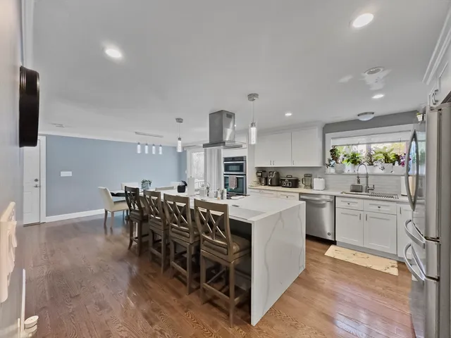 a kitchen with appliances a sink and cabinets