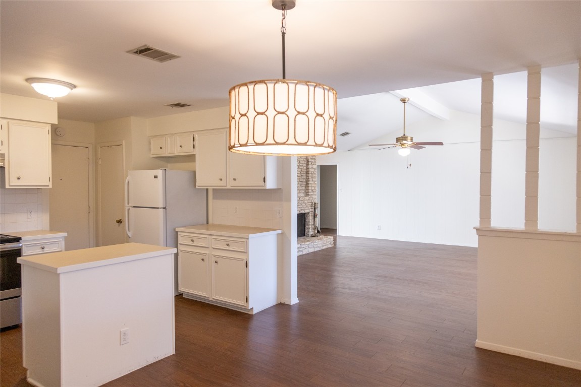 4205 Steve Scarbrough Drive Austin, TX 78759 - Photo 11 of 25 a view of a kitchen with a window and wooden floor