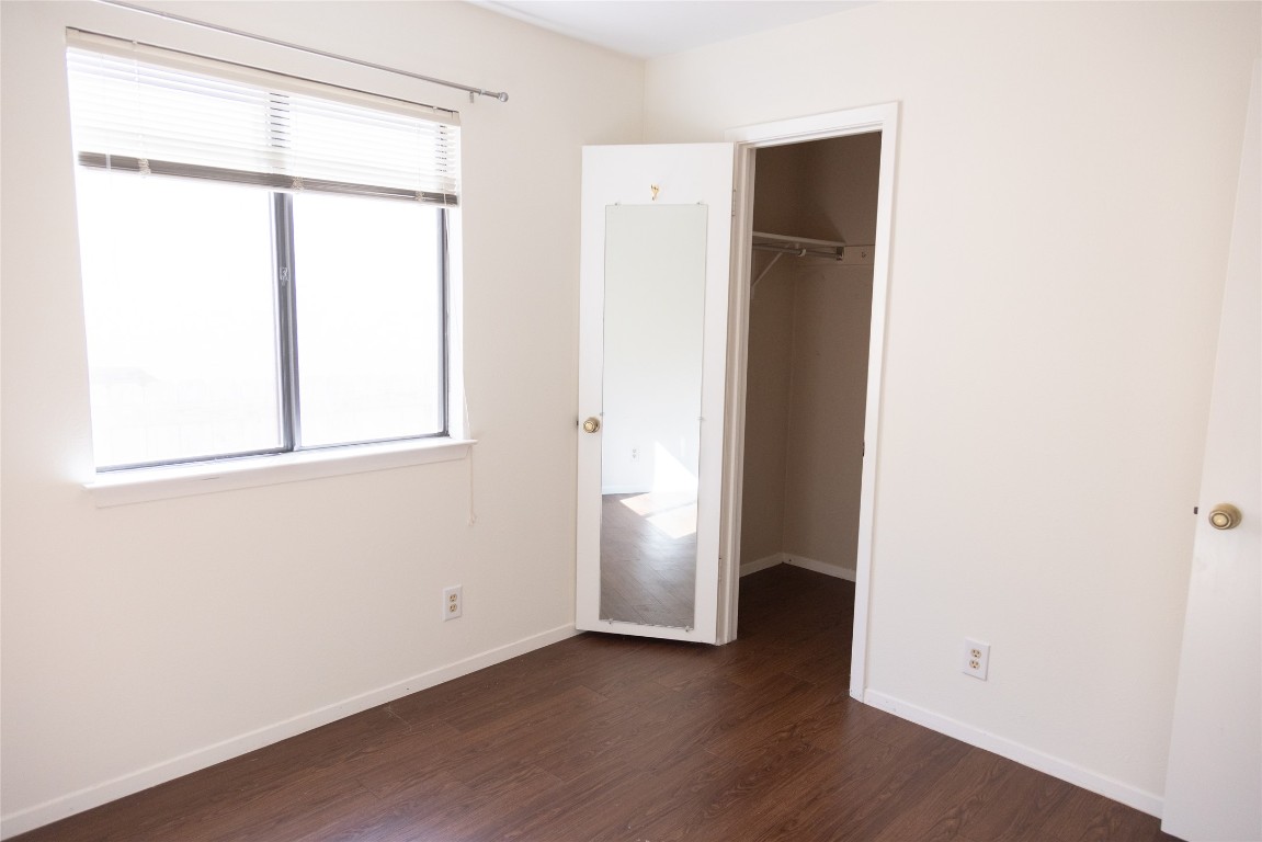 4205 Steve Scarbrough Drive Austin, TX 78759 - Photo 14 of 25 an empty room with wooden floor and a window