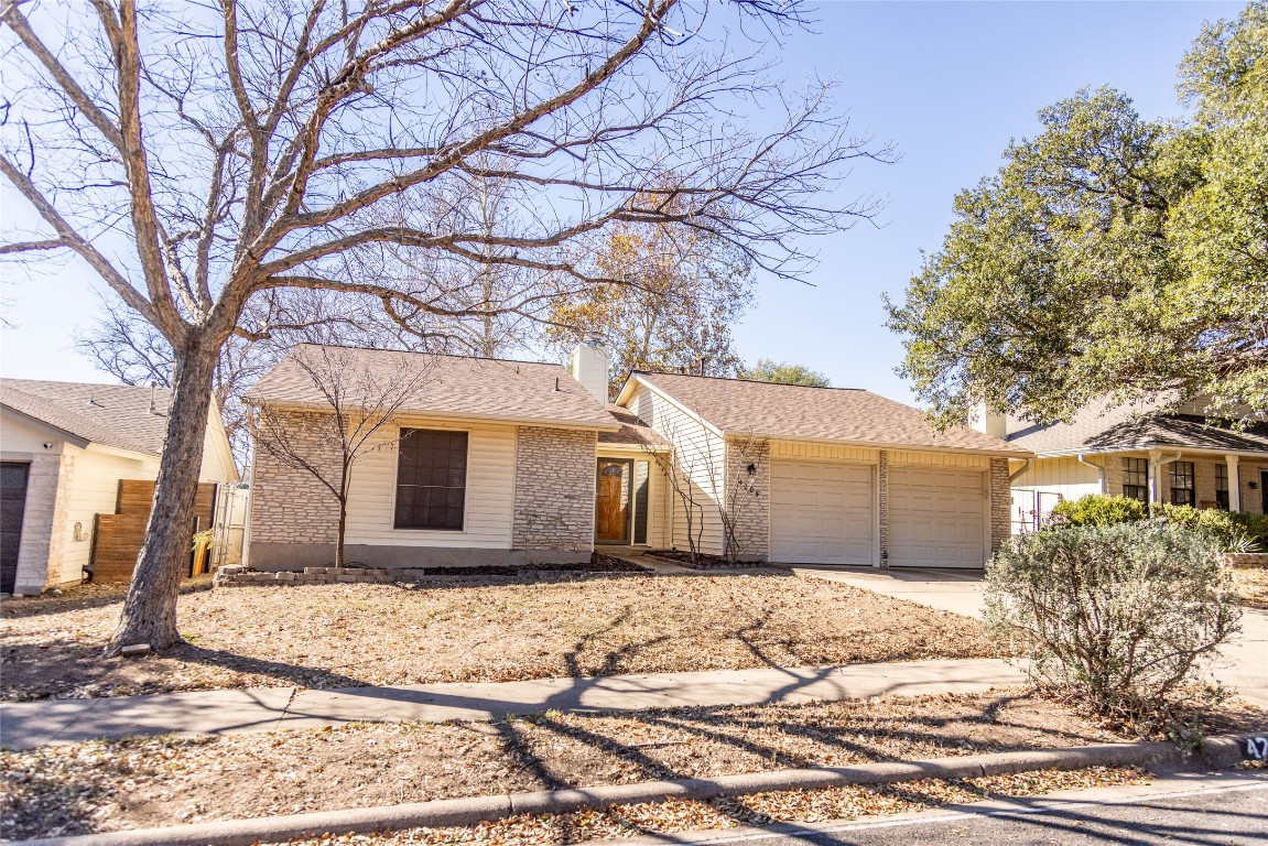 4205 Steve Scarbrough Drive Austin, TX 78759 - Photo 2 of 25 a front view of a house with a yard and garage