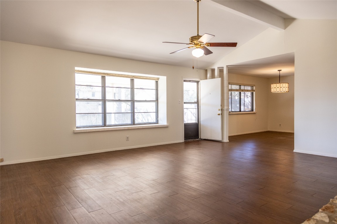 4205 Steve Scarbrough Drive Austin, TX 78759 - Photo 6 of 25 an empty room with wooden floor chandelier fan and windows