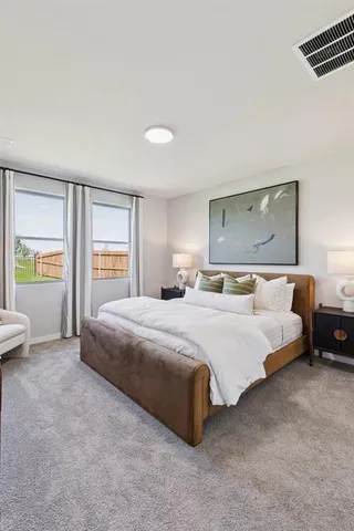 a bedroom with a large bed and a window