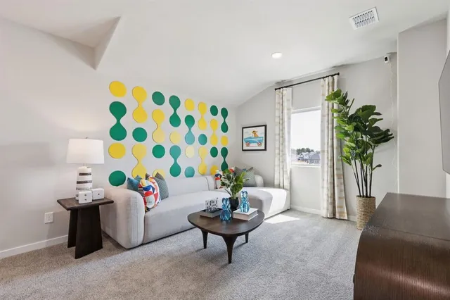 a living room with furniture and a potted plant