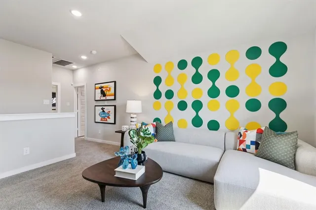 a living room with furniture and a potted plant