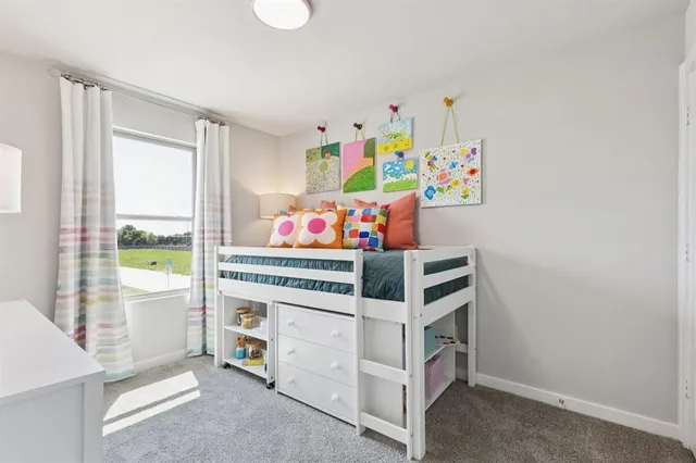 a bedroom with a bed and a dresser