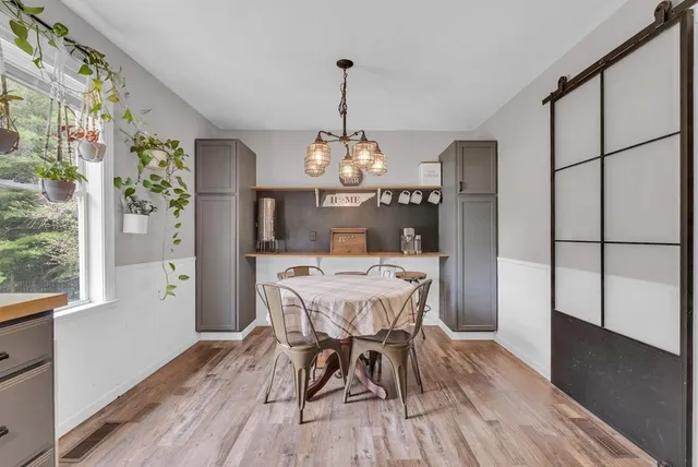 a view of a dining room with furniture window and wooden floor