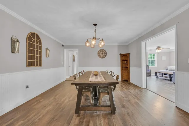 a view of a dining room with furniture wooden floor and chandelier