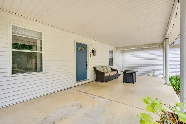 a view of a patio with table and chairs and potted plants