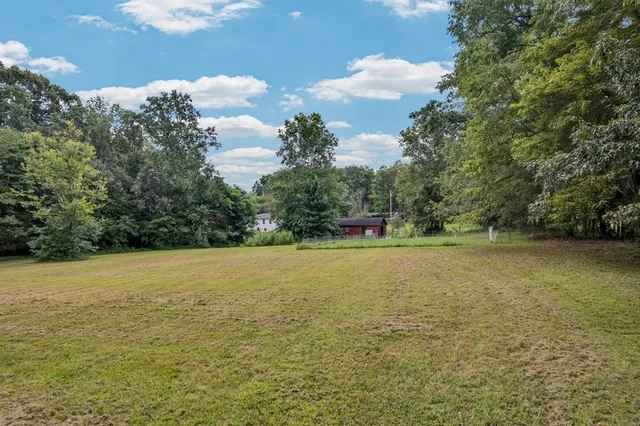 a view of a lake with large trees