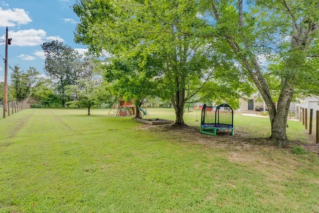 an aerial view of residential house with outdoor space and swimming pool