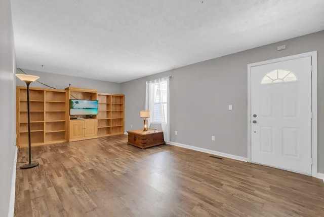 wooden floor in an empty room with a fireplace