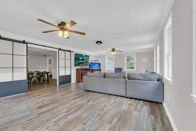 a living room with furniture and a wooden floor