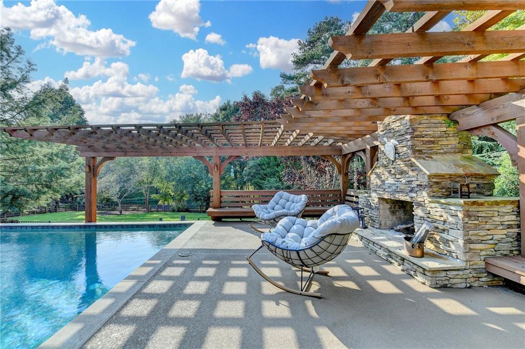 2850 Roanoke Road Cumming, GA 30041 - Photo 15 of 91 a view of a patio with table and chairs potted plants with wooden floor