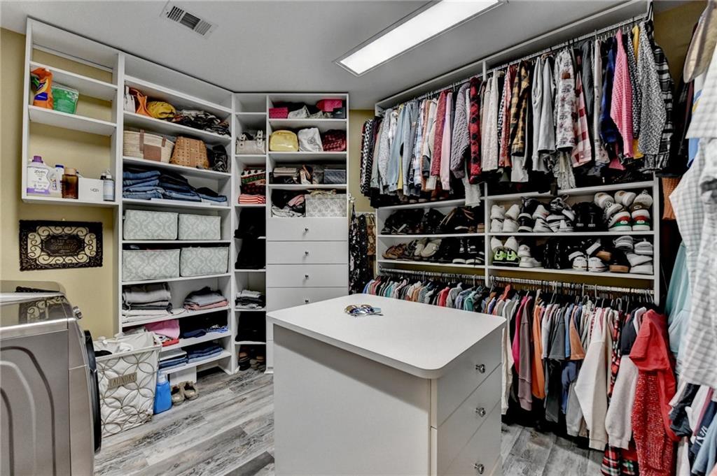2850 Roanoke Road Cumming, GA 30041 - Photo 40 of 91 a view of walk in closet with clothes and shoes