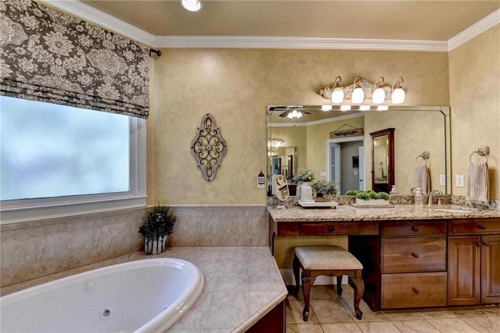 2850 Roanoke Road Cumming, GA 30041 - Photo 44 of 91 a bathroom with a granite countertop sink and a mirror