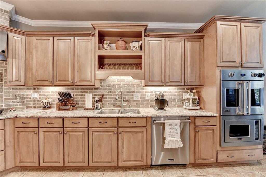 2850 Roanoke Road Cumming, GA 30041 - Photo 47 of 91 a kitchen with stainless steel appliances granite countertop a stove and cabinets