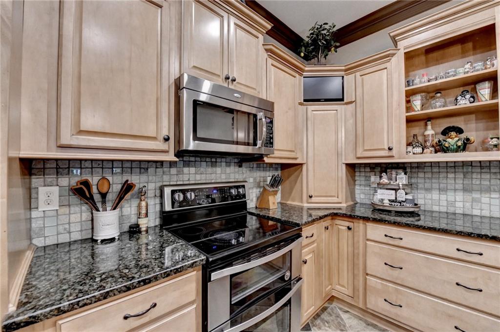 2850 Roanoke Road Cumming, GA 30041 - Photo 68 of 91 a kitchen with stainless steel appliances granite countertop a stove and a microwave