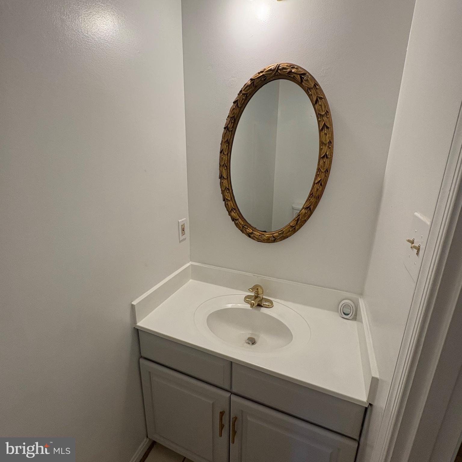 3502 Holly Road Annandale, VA 22003 - Photo 50 of 57 a bathroom with a sink and a mirror